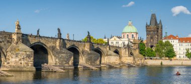 Charles Bridge and Old Town Bridge Tower at sunny day in Prague, Czech Republic. Panorama of the famous Karlov most bridge in summer