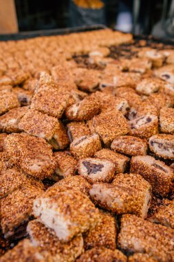 Sweet cookies with sesame seeds called Mardin Suryani coregi close-up on the street seller stall, Turkey. Traditional Syriac Pastry in Mardin old town