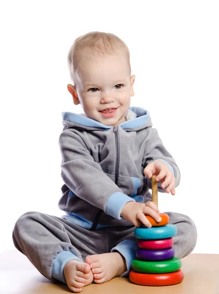 Little boy playing with pyramid — Stock Photo, Image
