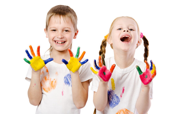 happy smiling children showing their hands painted in bright col