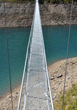 Alpine footbridge over lake