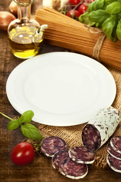 Whole wheat spaghetti, ingredients and plate for text — Stock Photo, Image