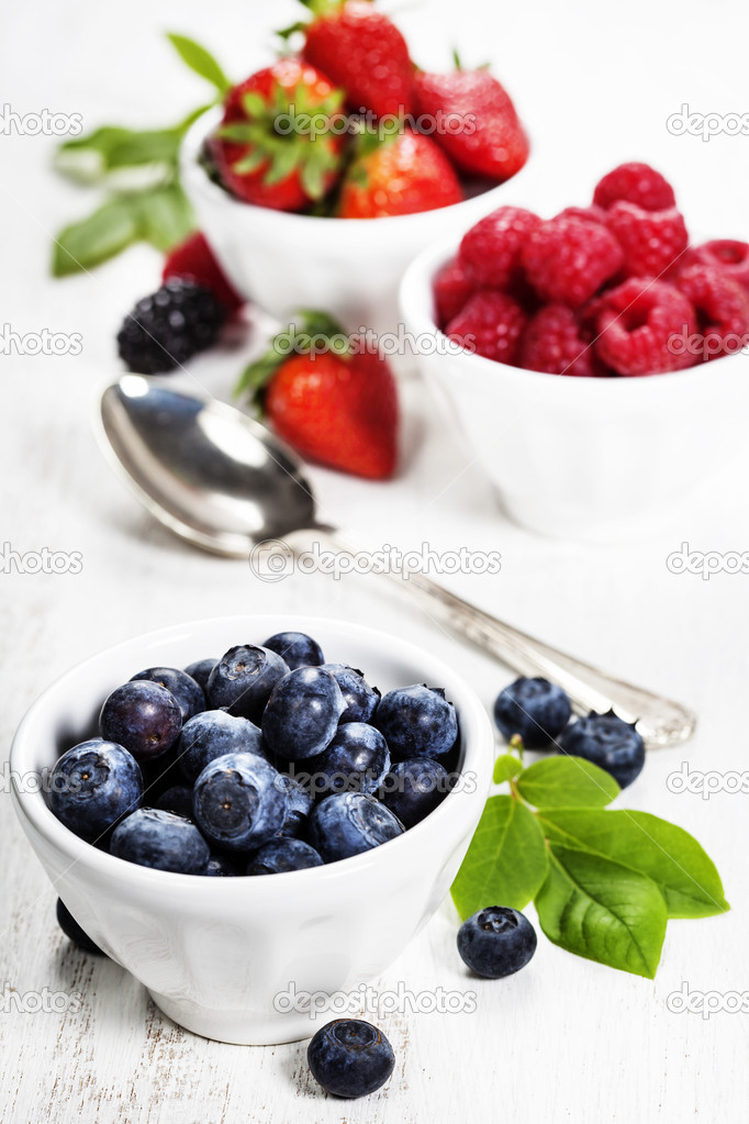 Berries in bowls  on Wooden Background.