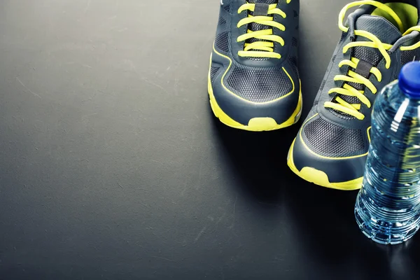 Zapatos deportivos y agua — Foto de Stock