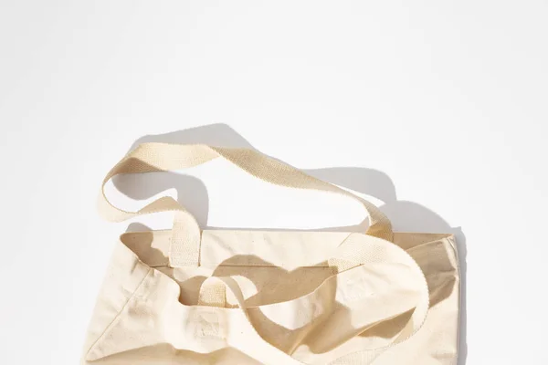 Eco-friendly cotton reusable bag on white background, flat lay, eco shopping — Stock Photo, Image