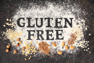 Gluten free written in flour on vintage baking sheet and gluten free grains and nuts clipart