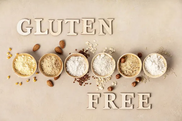 Various gluten free flour almond flour, oatmeal flour, buckwheat flour, rice flour, corn flour and gluten free lettering made of wooden letters