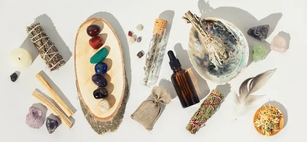 Healing crystals, elixir, palo santo, white sage bundle on abalone sea shell, dry healing herbs on white background — Stock Photo, Image
