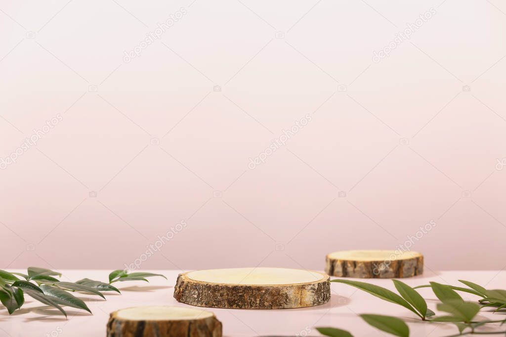 Wood slice podiums on pink background for cosmetic product mockup