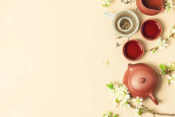 Asian Tea set on stone slate board, ceramic teapot, cups, dried tea and spring branches — Stock Photo, Image