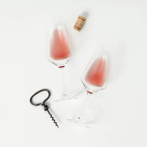 Rose wine in glasses. Flat-lay of wine glasses with rose wine on white background, top view. Wine tasting, winery, flat lay