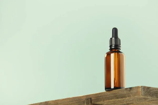 Amber Glass Dropper Bottle Black Lid Wood Shelf Green Background — Stock Photo, Image