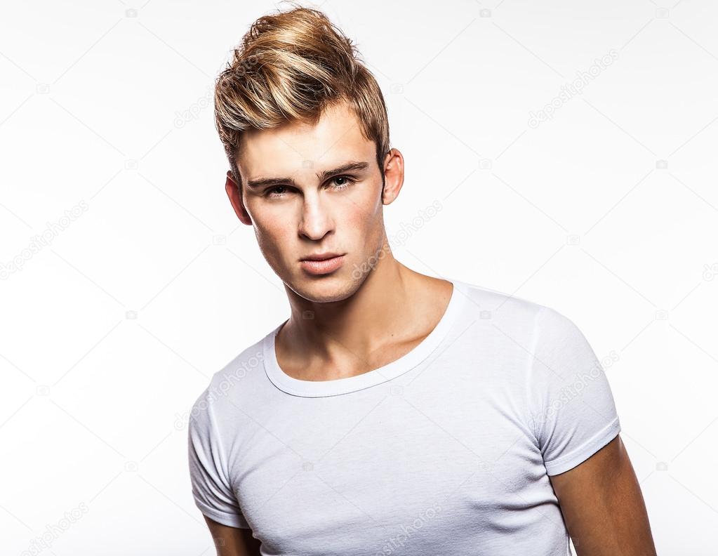 Attractive man wearing T-shirt close up portrait on white background.