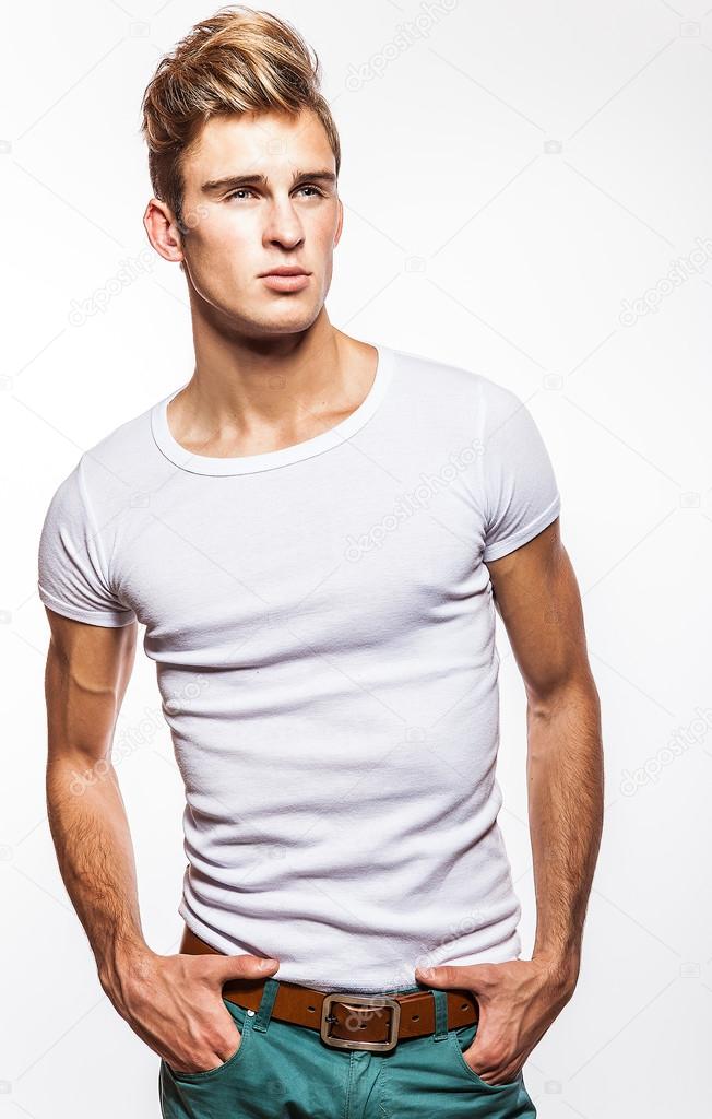 Attractive man wearing T-shirt close up portrait on white background.