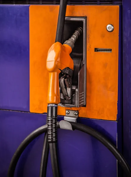 Gas pump nozzles in a service station — Stock Photo, Image