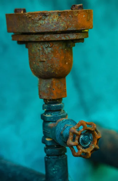 old rusty industrial tap water pipe and valve