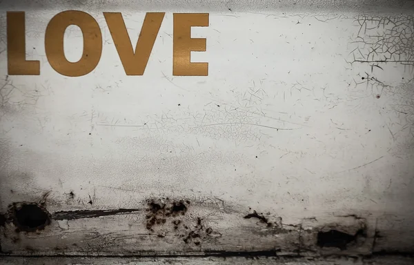Old grunge metal wall with the word "Love". Background photo. — Stock Photo, Image