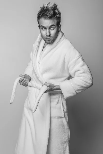 Handsome smiling young man in luxurious bathrobe. — Stock Photo, Image