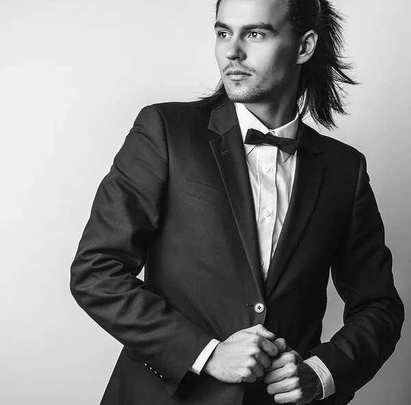 Elegante joven guapo hombre de pelo largo en traje. Estudio retrato de moda . —  Fotos de Stock