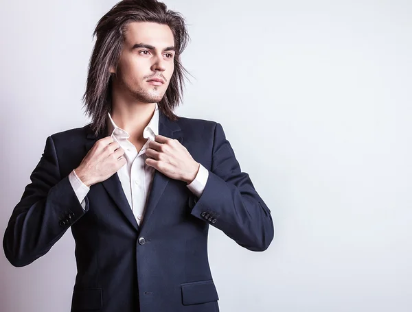 Elegant young handsome long-haired man in costume. Studio fashion portrait. — Stock Photo, Image