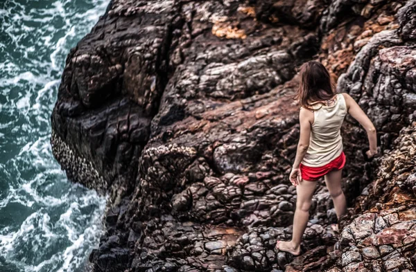 Beautiful young woman on the rock — Stock Photo, Image