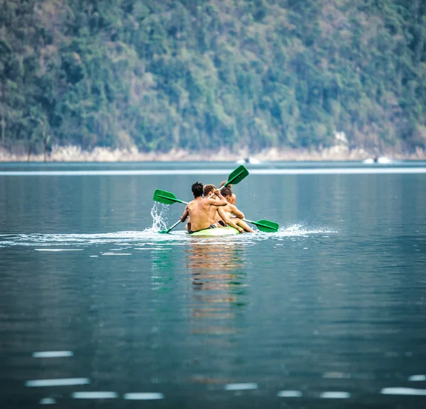 Strong young men in kayak — Stock Photo, Image