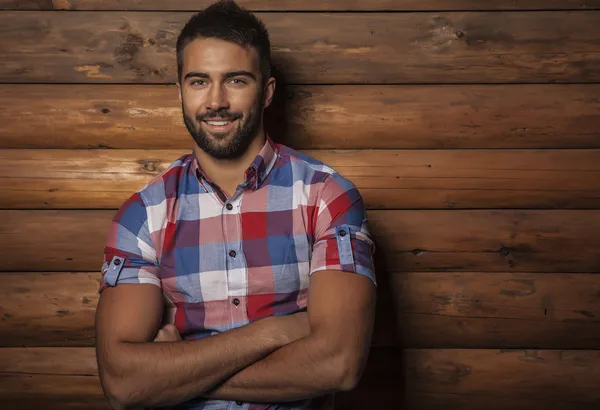 Portrait of young beautiful fashionable man against wood wall. — Stok Foto