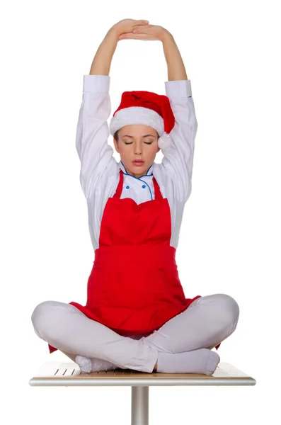 Bir kırmızı önlük ve şapka meditasyon cook — Stok fotoğraf