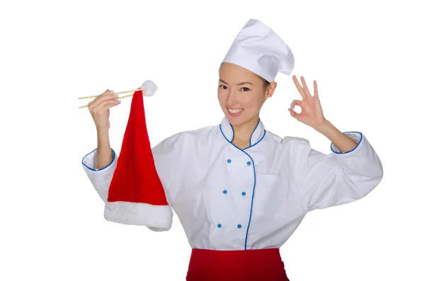 Chef holding chopsticks cap of Santa Claus — Stock Photo, Image