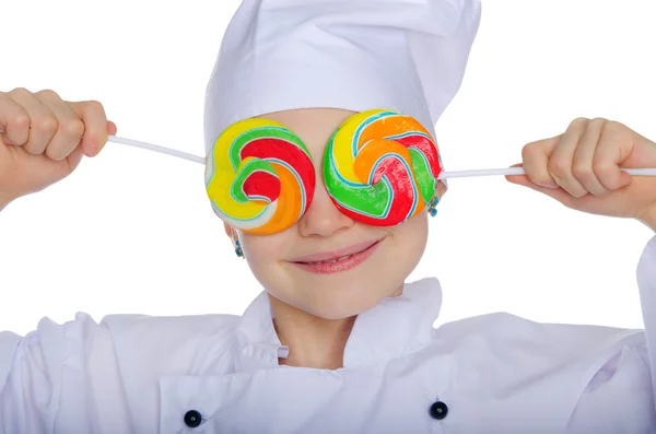 Young chef closed his eyes colored candies — ストック写真