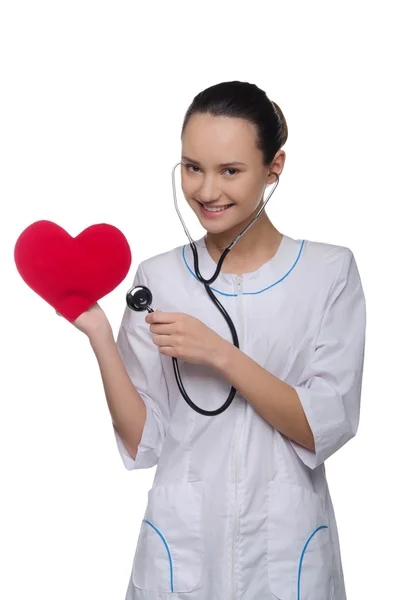 Doctor puts a stethoscope to the heart — Stock Photo, Image