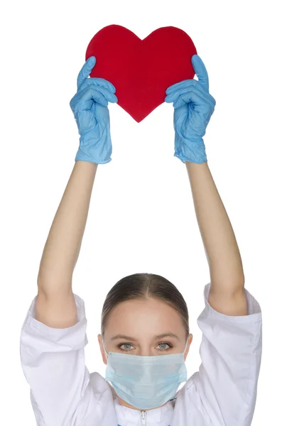 Verpleegkundige in masker opgehouden een hartsymbool — Stockfoto