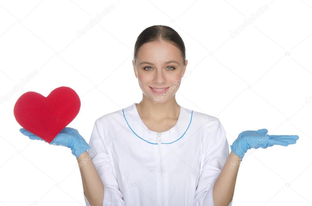Smiling female doctor weighs on hand heart symbol