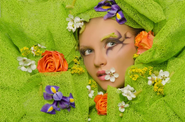 Beautiful woman in flowers — Stock Photo, Image