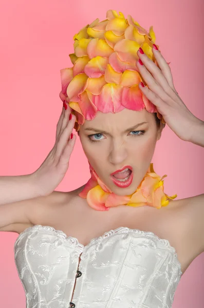 Emotional young woman in rose petals — Stock Photo, Image