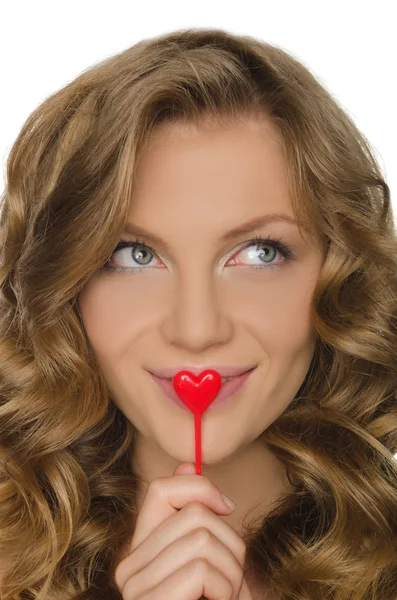 Young woman holding heart in front lip — Stock Photo, Image