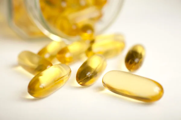 Macro of a bunch of yellow gel pills. — Stock Photo, Image