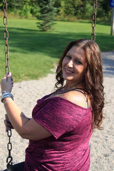 Beautiful 40 year old woman on swing — Stock Photo, Image