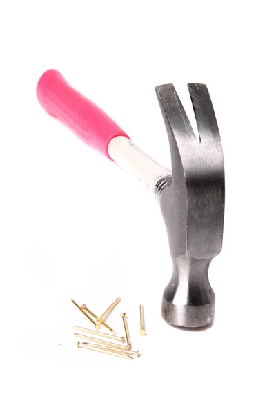 Pink hammer and golden nails on a white background — Stock Photo, Image