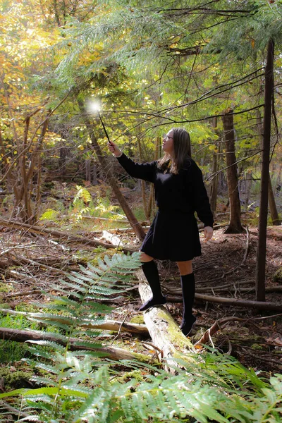 Young Woman Holding Looking Amazement Magic Wand Throwing Light Tip Rechtenvrije Stockfoto's