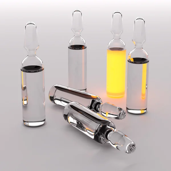 Ampules with transparent and orange liquid — Stock Photo, Image