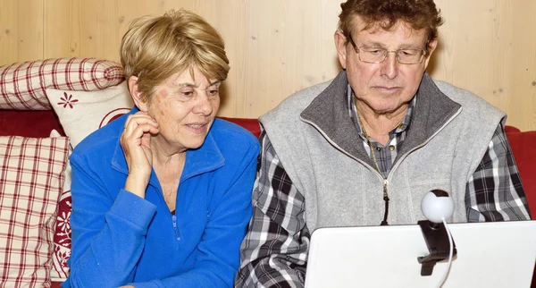 Старша пара використовує ноутбук для відеодзвінка — стокове фото