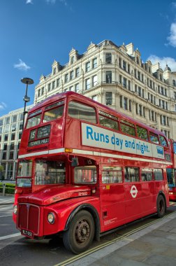 LONDON, SEP 28: Red double decker bus speeds up on the streets o clipart