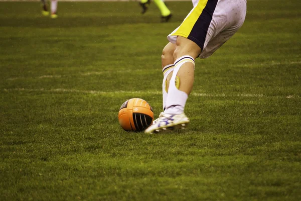 Chutando a bola durante uma partida de futebol — Fotografia de Stock