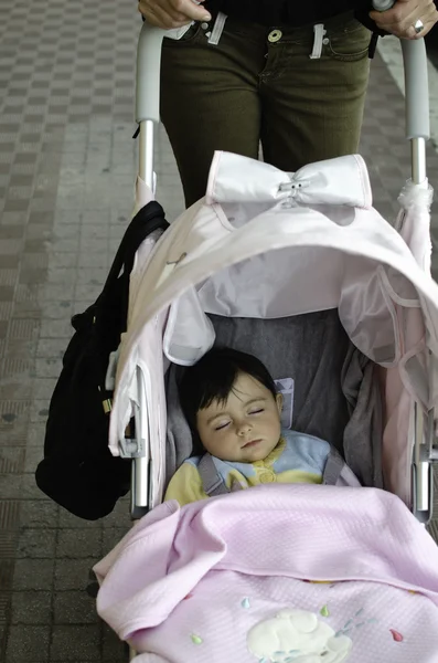 Baby slaapt in haar pram — Stockfoto