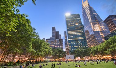 NEW YORK - MAY 17: People enjoying a nice evening in Bryant Park clipart