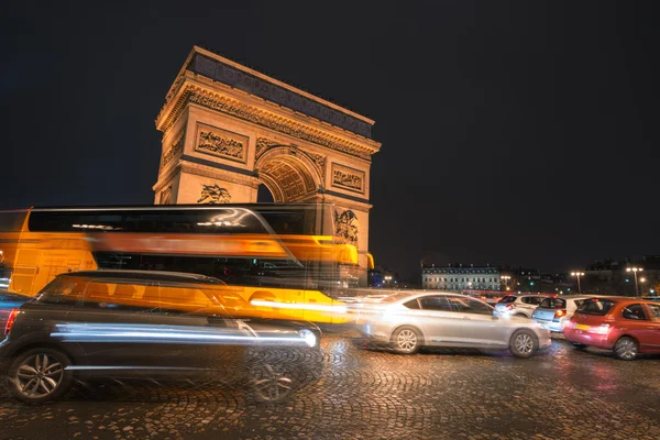 Paris traffic at night along Triumph Arc. Famous Etoile roundabo — Stock Photo, Image