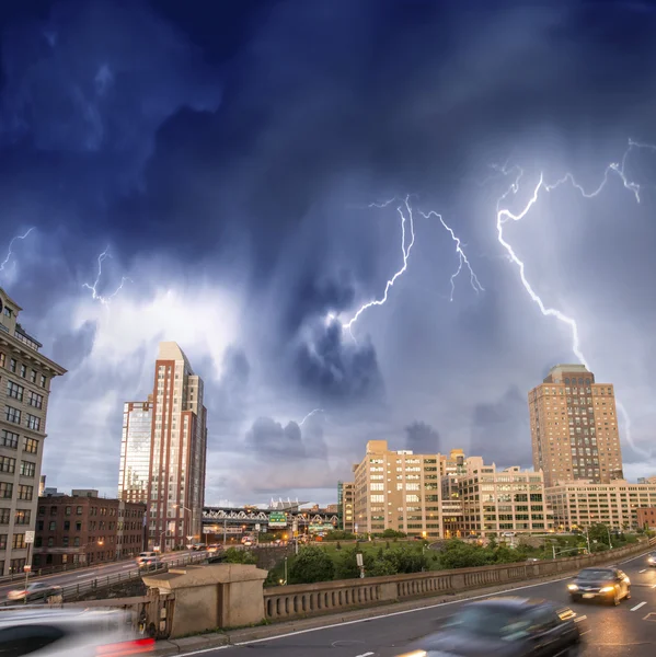 Escaping from city severe weather. Cars speeding up with lightni — Stock Photo, Image