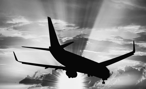 Aircraft silhouette flying at sunset — Stock Photo, Image