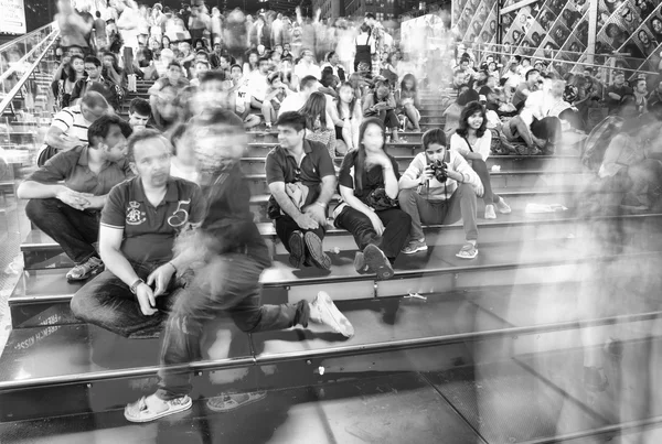 People on the red stairs of Duffy Square